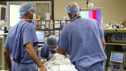 Anesthesiologists serving a patient.