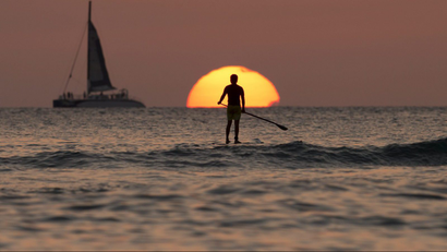 paddleboarding into the sunset
