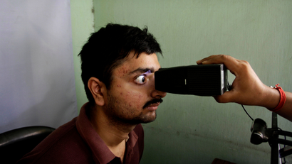 An Indian gets his retina scan done as he enrolls for Aadhar, India’s unique identification project in Kolkata, India, Wednesday, May 16, 2012.The giant identification project which aims to give everyone an identity record and number for the first time involves recording retina scans, fingerprints and photographs of all 1.2 billion Indians.