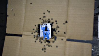 nien year old girl shot killed shoot mohave arizona uzi automatic machine gun accidental death firing shooting range parents supervision law gun A target hit several times is seen through a piece of cardboard also peppered with bullet holes at the DVC Indoor Shooting Centre in Port Coquitlam, British Columbia March 22, 2013. The range has large membership though the general public is also welcome. REUTERS/Andy Clark