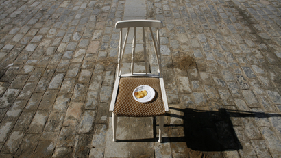 A plate of crisps is seen on a chair in a central street during a festival in Spain.