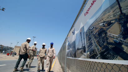 Iraqi staff from the West Qurna-1 oilfield, which is operated by ExxonMobil, walk during the opening ceremony near Basra in 2019