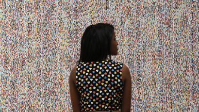 A visitor poses with artist James Hugonin's "Binary Rhythm (I)" at the press view of the Summer Exhibition 2011 at the Royal Academy of Arts in London, June 2, 2011.