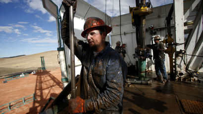 Roughneck Brian Waldner is covered in mud and oil while wrestling pipe on a True Company oil drilling rig outside Watford, North Dakota, October 20, 2012. Thousands of people have flooded into North Dakota to work in state's oil drilling boom. REUTERS/Jim Urquhart (UNITED STATES - Tags: ENERGY BUSINESS)