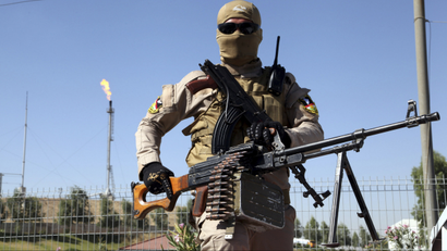 Kurdish peshmerga fighter guarding a refinery outside of Mosul on June 24, 2014.