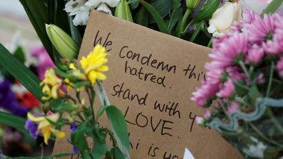 Flowers and signs are seen at a memorial as a tribute to victims of the mosque attacks, near a police line outside Masjid Al Noor in Christchurch, New Zealand,