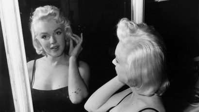 In conference - Actress Marilyn Monroe, film star turned business executive, checks her lines - all curves - in a mirror at the photographic studio of her business partner, Milton Greene, in New York Jan. 28, 1955. A contract wrangle with 20th century-fox threatens to delay Marilyns recently announced plans to do some movie producing on her own. Greene, a commercial photographer, says he is going to be vice president of the newly formed Marilyn Monroe Productions, Inc. (AP Photo)