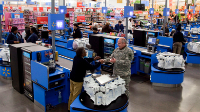 In this photo taken Dec. 15, 2010, the check-out inside a Wal-Mart store in Alexandria, Va., is shown. The battleground for the biggest fight in retailing today is being played out along this suburban highway. Going head-to-head: Wal-Mart against everyone else.