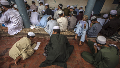 Pakistani religious students attend a lesson at a Darul Uloom Haqqania, an Islamic seminary and alma mater of several Taliban leaders in Akora Khattak