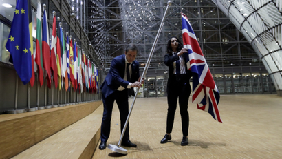 Officials remove the British flag at EU Council in Brussels