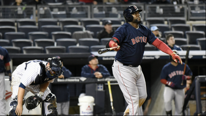 Boston Red Sox's David Ortiz watches his home run as New York Yankees catcher Brian McCann, left, reacts during the 16th inning of a baseball game Friday, April 10, 2015, at Yankee Stadium in New York.
