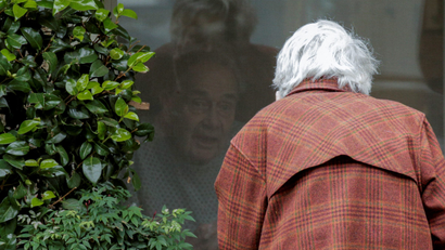 Gene Campbell talks through a window with his wife of more than 60 years, Dorothy Campbell, at the Life Care Center of Kirkland, the long-term care facility linked to several confirmed coronavirus cases in the state, in Kirkland