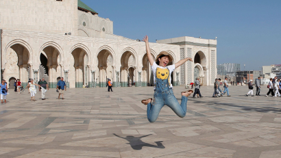 Chinese tourists jump as they pose for photographs at the esplanade of the Hassan II Mosque in Casablanca, October 6, 2016. REUTERS/Youssef Boudlal