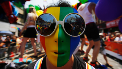 A man wearing a rainbow mask is seen during the" WorldPride" gay pride Parade in Toronto
