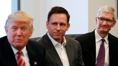 U.S. President-elect Donald Trump speaks as PayPal co-founder and Facebook board member Peter Thiel and Apple Inc CEO Tim Cook look on during a meeting with technology leaders at Trump Tower in New York U.S., December 14, 2016.