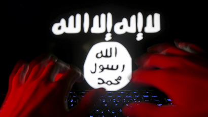 Picture illustration taken in Zenica shows man typing on a keyboard in front of a computer screen on which an Islamic State flag is displayed