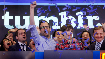 David Karp, third from right, Founder and CEO of Tumblr, reacts as confetti flies during the opening bell at Nasdaq, Thursday, July 11, 2013 in New York. Derek Gottfrid, Tumblr vice president, raises his fist. Yahoo acquired the online blogging forum for $1.1 billion in June. Tumblr will remain independently operated and Karp will stay CEO. (AP Photo/Mark Lennihan)