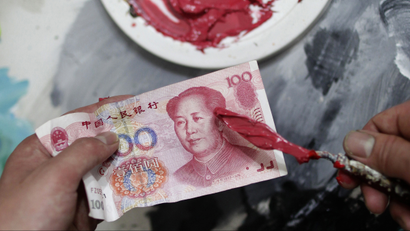 DATE IMPORTED:May 02, 2011A painter contrasts the reddish-pink hue on a painting knife with China's 100 yuan banknote before he works on portraits for Chinese artist and film-maker Zhang Bingjian's "Hall of Fame" project in a studio in Shenzhen, south China's Guangdong province, April 25, 2011. The stark, monochromatic portraits rendered in the reddish-pink hue of China's 100 yuan banknotes, painted by a team of artists in Shenzhen's Dafen village -- known for its mass-produced knock-offs of iconic Western paintings -- are the brainchild of outspoken Zhang. Picture taken on April 25, 2011. To match Reuters Life! CHINA-ART/CORRUPTION REUTERS/Jason Lee