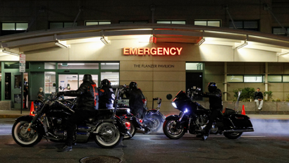 Members of a Motorcycle club perform a burn out during a vigil for musician and actor DMX outside White Plains Hospital in White Plains, New York