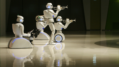 Toyota Motor Corp's partner robots play instruments at the company's showroom in Tokyo