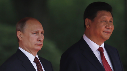 China's President Xi Jinping (R) and his Russian counterpart Vladimir Putin attend a welcoming ceremony at the Xijiao State Guesthouse, before the fourth Conference on Interaction and Confidence Building Measures in Asia (CICA) summit in Shanghai May 20, 2014. Trade between China and Russia is expected to reach $100 billion by 2015, Xi said on Tuesday, after meeting with Putin.