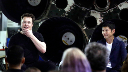 SpaceX founder and chief executive Elon Musk, left, speaks after announcing Japanese billionaire Yusaku Maezawa, right, as the first private passenger on a trip around the moon, Monday, Sept. 17, 2018, in Hawthorne, Calif.