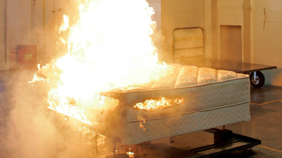 Automatic sprinklers extinguish a mattress fire at the Sealy testing lab in Trinity, N.C., Wednesday, June 20, 2007. The federal Consumer Product Safety Commission wrote new flammability standards aimed at reducing the number of mattress fires started by open flames such as candles and lighters. The commission calls it the most expensive regulation handed down to any industry in its history, and one it hopes will prevent as many as 270 deaths a year.