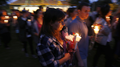 UC Santa Barbara students attend a candlelight march and vigil following Friday's series of drive-by shootings that left seven people dead in the Isla Vista section of Santa Barbara May 24, 2014. A lone gunman sprayed bullets from a car in a drive-by shooting in a southern California college town, killing at least six people before his car crashed and he was found dead inside, authorities said on Saturday. REUTERS/Jonathan Alcorn