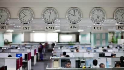 Workers are pictured beneath clocks displaying time zones in various parts of the world at an outsourcing centre in Bangalore, February 29, 2012. India's IT industry, with Bangalore firms forming the largest component, is now worth an annual $100 billion and growing 14 percent per year, one of the few bright spots in an economy blighted by policy stagnation and political instability. Picture taken on February 29, 2012.