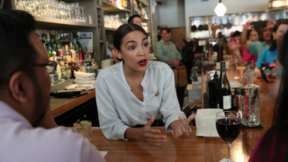 Rep. Alexandria Ocasio-Cortez (D-NY) serves drinks in support of One Fair Wage at The Queensboro restaurant in the Queens borough of New York