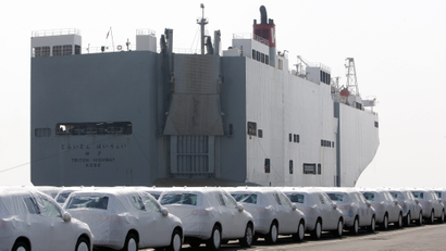 New Volkswagen cars line up outside a transport ship.