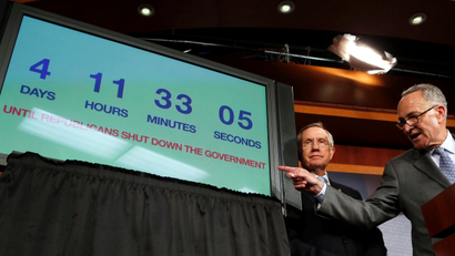 U.S. Senate Majority Leader Harry Reid (L) and Senator Charles Schumer stand next to a countdown clock while they discuss the potential U.S. government shutdown in four days, on Capitol Hill in Washington September 26, 2013. Reid, a Democrat, on Thursday rejected plans by Republicans in the House of Representatives to advance a debt limit increase bill that contains measures such as delaying "Obamacare."