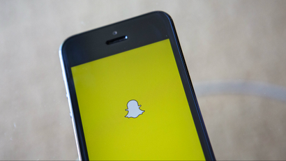 A portrait of the Snapchat logo on a smartphone.