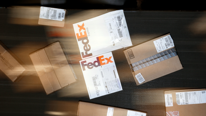 In this July 9, 2014 photo, packages are moved on a conveyor belt at the FedEx Express station in Nashville, Tenn.