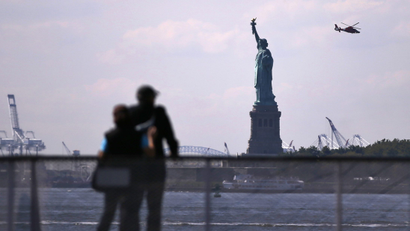 Tourists pause to view the Statue of Liberty