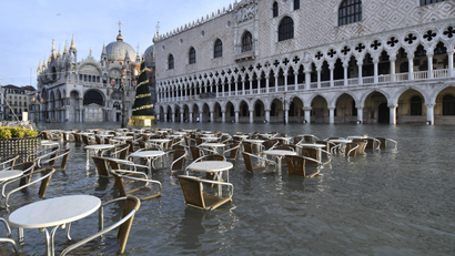Cafè tables and chairs are partially covered in water during a high tide of 1.44 meters (4.72 feet), in St. Mark's Square, in Venice, Italy, Monday, Dec. 23, 2019.
