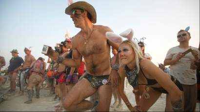 People at Burning Man getting ready for a race.