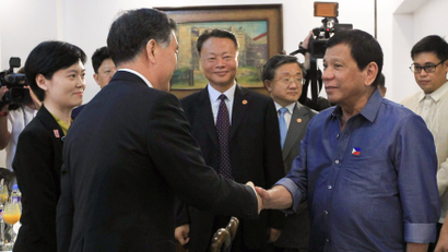 Philippine President Rodrigo Duterte greets Vice Premier of China, Wang Yang (L) during his courtesy call at the Presidential Guest House in Davao city, Philippines March 17, 2017.
