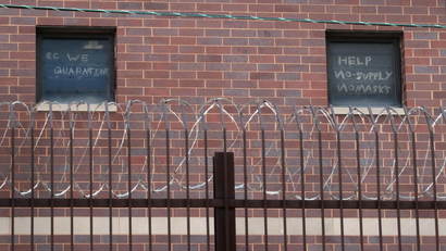 Inmates ask for help writing on the windows of Cook County Jail's windows 