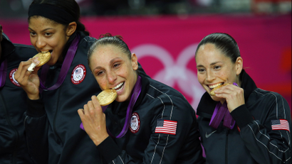 Athletes biting medals.