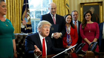 Donald Trump signs an executive order to review bank regulations