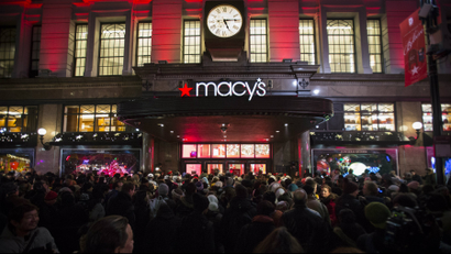 Shoppers wait to enter Macy's to kick off 2014's Black Friday sales in New York.