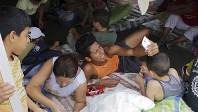 Residents take a selfie under a tent at the Reales Tamarindos airport, after being evacuated from their homes in Portoviejo, after an earthquake struck off Ecuador's Pacific coast