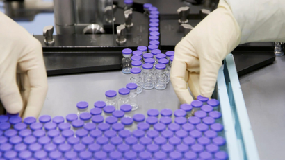 Vials of coronavirus disease (COVID-19) vaccine candidate BNT162b2 are sorted at a Pfizer facility in Puurs, Belgium in an undated still image from video.