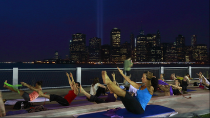 A pilates class on top of a building.