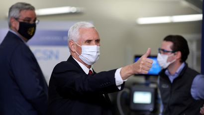 Mike Pence wears a mask and makes a thumbs-up gesture