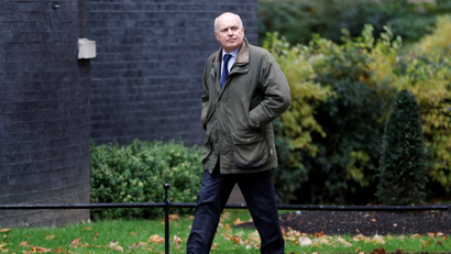 Iain Duncan Smith walks outside Downing Street in London