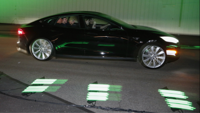 People test drive the new all-wheel-drive version of the Tesla Model S car in Hawthorne, California October 9, 2014.
