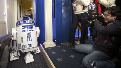 R2D2 greets members of the press during a surprise visit to the Brady Press Briefing Room of the White House, Friday, Dec. 18, 2015. The Star Wars movie characters will greet children of Gold Star families who are attending a special screening of Star Wars The Force Awakens later today at the White House Family Theater. (AP Photo/Pablo Martinez Monsivais)