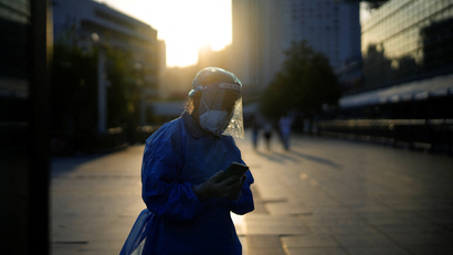 A woman wearing a protective suit in Shanghai.